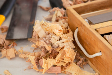 Stack of wood dust on wooden DIY background, sawdust on table in Carpentry Studio shop, DIY wooden...