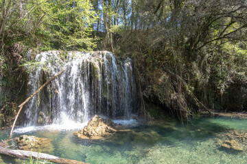 Beautiful waterfall on a bright sunny day in a famous river in Girona