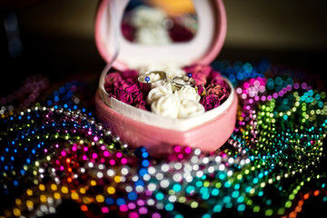 Jewelry box with rings and roses. A heart-shaped jewelry box opened to reveal rings and decorative...