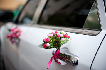 Wedding car with floral decor. Colorful floral decorations enhance the elegance of a wedding car...