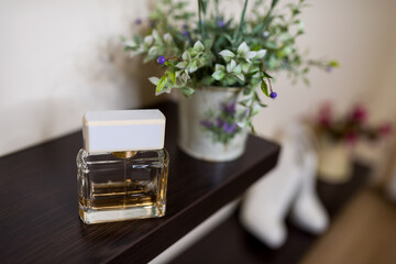 Elegant perfume bottle on wooden shelf. A delicate perfume bottle sits on a wooden shelf,...