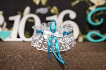 Blue and white bridal garter. Delicate bridal garter adorned with lace and blue ribbons displayed...
