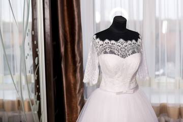 Elegant wedding dress displayed. A beautiful wedding dress featuring lace details and a full skirt...