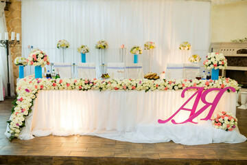 Floral decor for celebrations. A beautifully decorated table loaded with flowers and delicacies, set for a special event at a festive venue.
