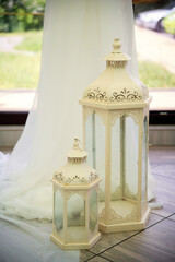 Serene decorative lanterns. Two vintage lanterns stand gracefully, adding charm to a peaceful indoor space with soft natural light filtering in.