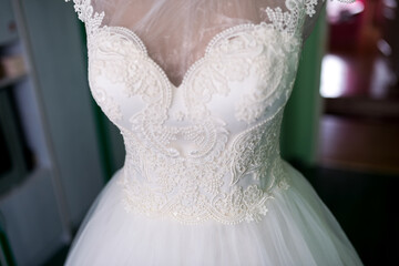 Lace white wedding dress. A stunning white wedding dress displays intricate lace designs and a fitted bodice, perfect for a bride's special day.