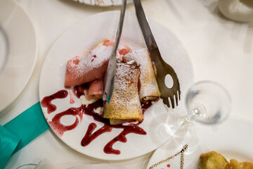 Sweet love sauce dessert. Sweet crepes with powdered sugar and sauce create a delicious and charming dessert.