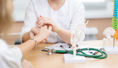 Doctor rheumatologist diagnostics arthrosis of hands of patient. Medical consultation with client...
