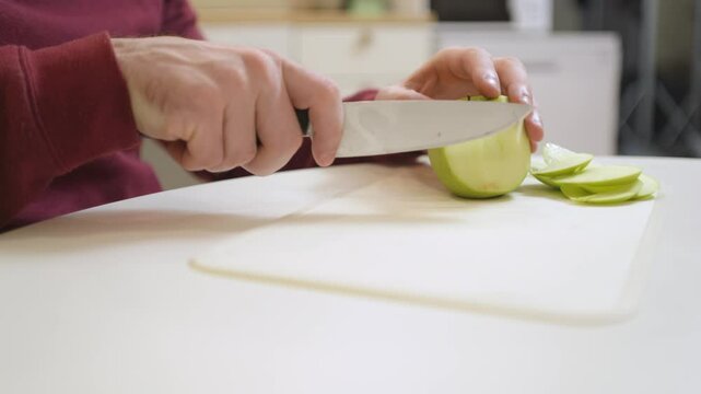 A 30-year-old man enjoys a casual meal and drink in his kitchen, captured in a natural, unposed moment. Authentic and relatable everyday scene perfect for lifestyle and food content