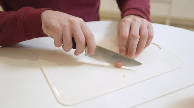 A 30-year-old man enjoys a casual meal and drink in his kitchen, captured in a natural, unposed moment. Authentic and relatable everyday scene perfect for lifestyle and food content