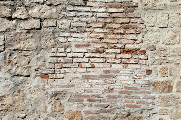 Textured weathered old stone and brick  wall of a house in a small village in the Eagean region of Turkey