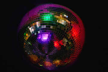 Night dance club. Glowing shiny disco ball,colored ceiling