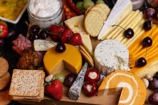 Cheeseboard Selection with Fruit and Snacks close up