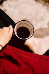 A woman sits outdoors holding an empty coffee cup. Top view. Great for lifestyle blogs, morning...