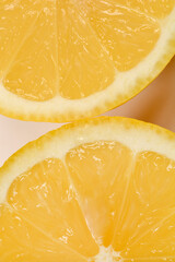 A close-up of two juicy lemon halves on a light background