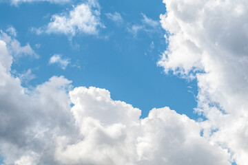 Bright blue sky with white fluffy clouds