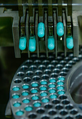 Close up capsule medicine pill production line, Industrial pharmaceutical concept.	
