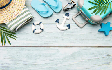 Summer vacation accessories lying on wooden background with copy space