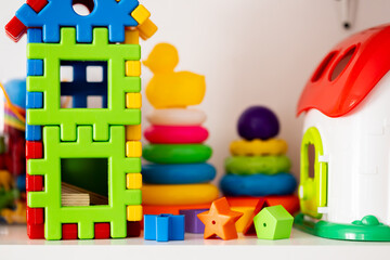 Geometric toys and stacking blocks on a kids’ shelf. Useful for parenting blogs, preschool design...