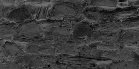 Textured stone wall with abstract pattern in monochromatic dark tones providing rustic and natural background designs for creative projects