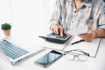 Accountant working on desk using calculator for calculate finance report in office. business...
