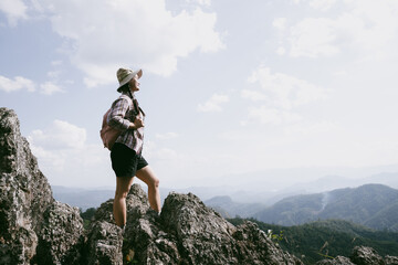 Woman hiker on top of mountain. Hiker with arms up on top of mountain successful young woman enjoying triumph. traveler exploring world. Hikers with backpacks relaxing. Sport and success concept.
