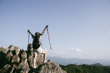 Woman hiker on top of mountain. Hiker with arms up on top of mountain successful young woman...