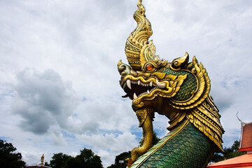 Fototapeta premium Ancient art of naga or antique naka statue of Wat Phra Kaew temple for thai people travelers travel visit and respect praying and blessing holy mystery worship at Chainat city in Chai Nat, Thailand