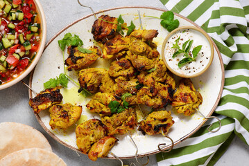 Persian chicken kebab with yogurt sauce, pitas and shiraz vegetable salad.selective focus