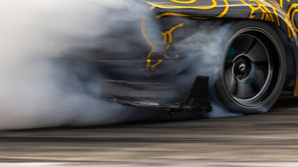 Car drifting, Blurred image diffusion race drift car with lots of smoke from burning tires on speed track, Car drifting on speed track, Professional driver driv drifting car. © Kalyakan