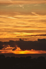 Sunset skyline with glowing gradient sky and dramatic light clouds