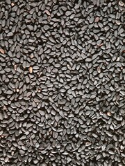 Black cumin seeds fill the frame, top view, pattern