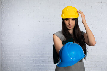 A woman in a construction site wearing a safety helmet, demonstrating her skills and confidence