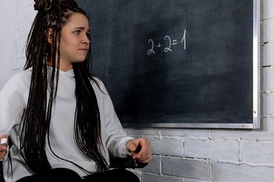 A Concerned Student Facing a Challenging Math Problem on the Chalkboard in Class - Powered by Adobe