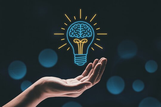 Hand holding glowing light bulb with brain inside, creative idea innovation and thinking concept.
