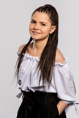 This is a beautiful portrait of a young woman showcasing her braided hair and stylish attire