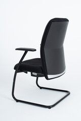 This is a modern black office chair distinguished by its sleek and contemporary design