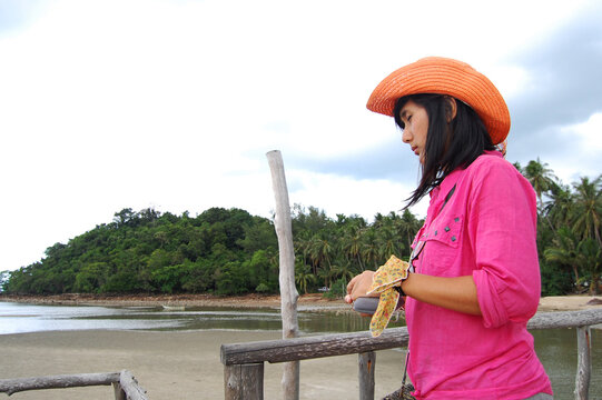 Travelers thai women walking on wooden bridge and pier building use service long tail local boat go Koh Pitak or Ko Phithak Island for eco travel visit and rest relax homestay in Chumphon, Thailand