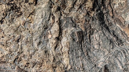 Rough surface of natural stone showing intricate patterns and textures
