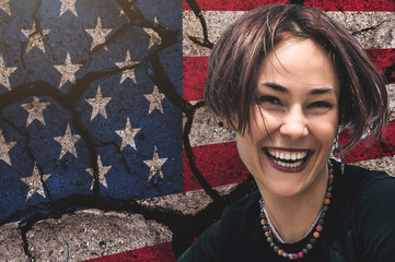 Happy young woman against the background of the cracked US flag