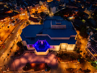 Novi Sad, Serbia - June 26, 2025: View of modern building of the Serbian National Theatre is located in the old center of Novi Sad. Night aerial photography.