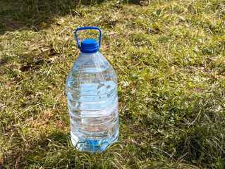 A plastic water bottle sitting in the grass