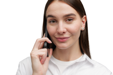 Engaging conversation with a friendly smile from a young woman using a smartphone in a bright, empty background