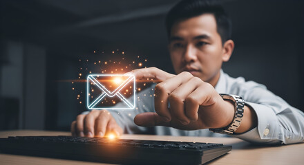 Man interacting with digital email icon above keyboard in a dark environment on transparent background