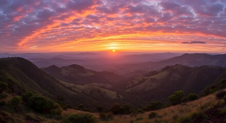 Fototapeta premium Vibrant sunset over majestic mountain ranges, creating a breathtaking landscape