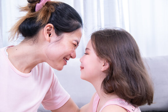 Mother, kids, cosmetic, child, beauty, A cheerful mother and daughter touching foreheads playfully, showing love, family bonding, emotional connection, and joy during fun beauty time together