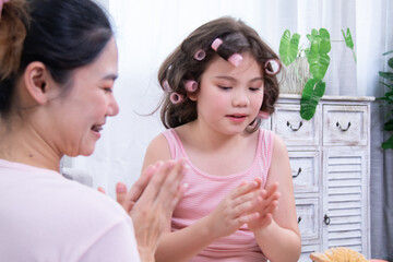 Kids, cosmetic, child, beauty, girl, A girl with curlers talks to her mother during a home beauty...