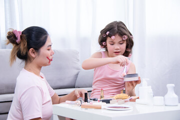 Obraz premium Kids, cosmetic, child, beauty, girl, A cheerful moment between Asian mother and mixed daughter as they playfully apply makeup together, expressing love, laughter, and family connection at home