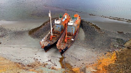 Aerial view of two abandoned shipwrecks.