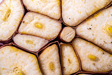 Garlic, head in a close-up cut, background with garlic texture. Macro photography